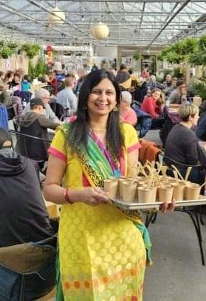 A full-length photo of Anita Jogi in a colorful sari with exotic jewelry