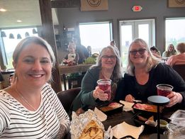 Three customers enjoying Indian food and cider inside Townline Ciderworks